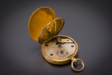 Vintage Swiss clockwork mechanism. Gold pocket watch on stone background. Gold Silver Precision...
