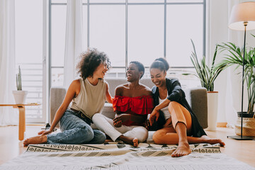 Beautiful and young latin american women having fun and bonding at home - Three pretty hispanic...