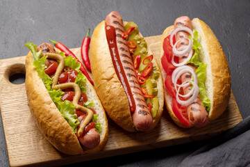 Various hot dog on wooden board