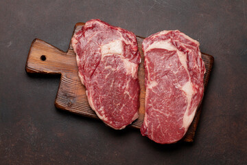 Two raw ribeye beef steaks
