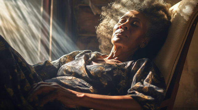 Elderly african-american woman resting on a sofa in sunlight