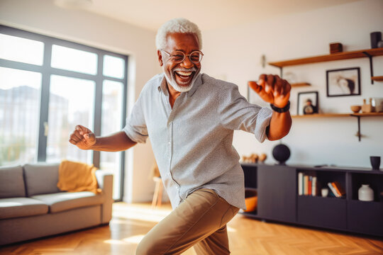 Positive black older man dancing at home. Happiness and well being concept.