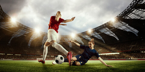 WOrld football cup. Two women, professional football players competing for the win, playing on 3D open air arena. Concept of professional sport, competition, dynamics, game, ad