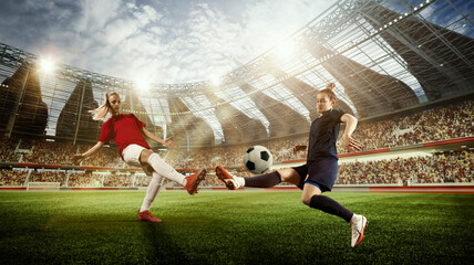 Concentrated young women, soccer, football players in motion, during match, playing o 3D football...