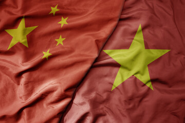 big waving national colorful flag of china and national flag of vietnam .