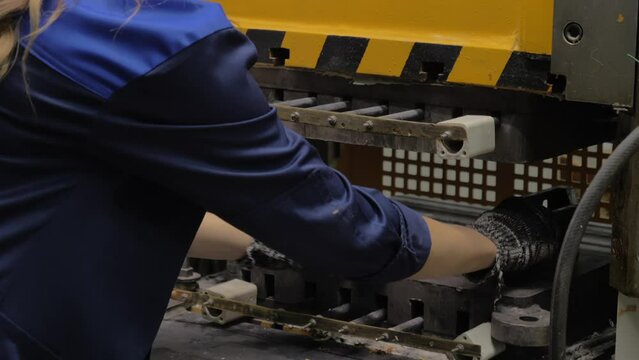 Female Operator during Shift. Collecting Metal Parts. Manufacturing of Radio Components. Inside a Modern Electronics Production Facility. Slow Motion. Modern Machines and Equipments. Close up