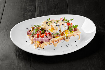 Belgian waffle with ham, cheese, chili pepper, poached egg and fresh arugula
