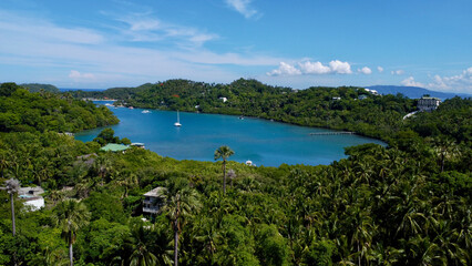 Tropical islands in the Pacific Ocean. Aerial view of the islands, beach and boats in the bay.