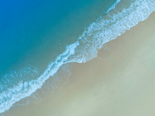 Beach Wave water in the Tropical summer beach with  sandy beach background