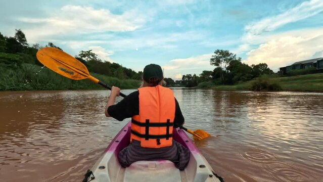 Young woman rowing in kayak summer trip 4K active lifestyle kayaking concept footage, Thailand.