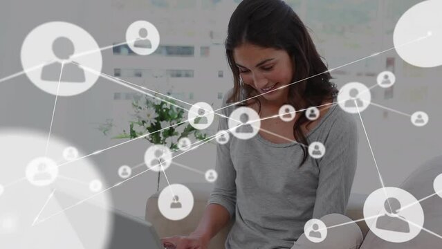 Animation of network of connections with icons and caucasian woman buying online