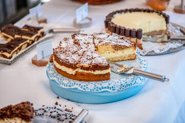 Table full with beautiful and delicious cakes at wedding reception Buffet