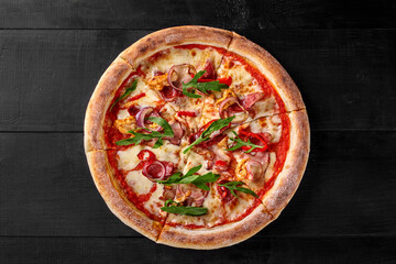 Pizza with sous vide chicken, bacon, salami, spicy pepper, onion and arugula
