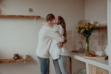 Couple husband and wife hugging in the kitchen expecting of the baby, pregnancy