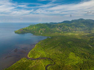 Aerial view of Tropical Island and blue sea with blue sky and clouds. Mindanao, Philippines.