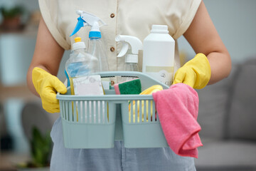 Woman, hands and detergent basket for cleaning, housekeeping or disinfection of dirt at home. Closeup of female cleaner holding container of chemical bottles, products or liquid tools of maid service - obrazy, fototapety, plakaty