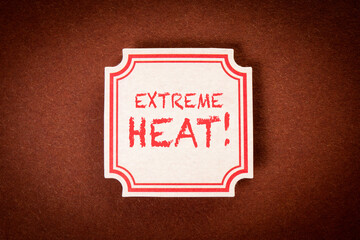 Extreme Heat. Sticky note with text on a brown textured background