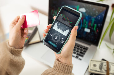 ICO concept - hand clicks on smartphone with abstract graphics.