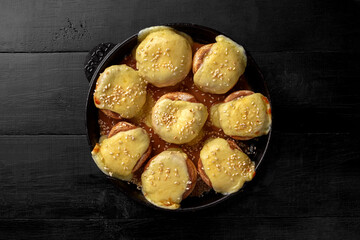 Baked champignon caps stuffed with suluguni in iron pan