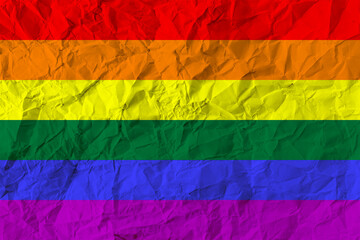 Background with the colors of the rainbow LGBT flag with the effect of crumpled paper. Wrinkles texture.