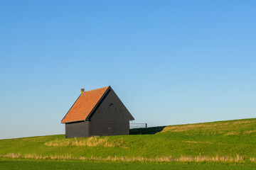 Dutch dike with Dutch dike shed, Netherlands.