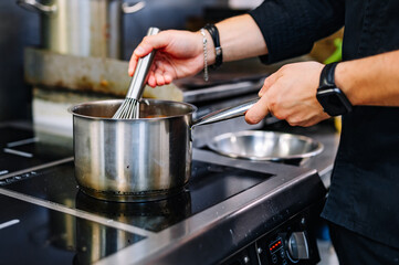 Chef cook hand cooking food at the restaurant kitchen