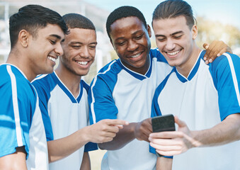 Happy man, friends and soccer team with phone for social media, communication or online browsing outdoors. Group of football players smile on mobile smartphone app together after workout practice © Wesley JvR/peopleimages.com