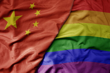 big waving national colorful flag of china and rainbow gay pride flag