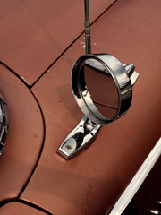 Sideview mirror of an old vintage car, conceptual vintage transportation
