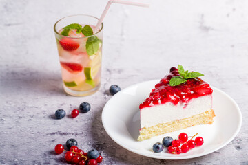 Cheesecake with fresh strawberries, red currants and blueberries