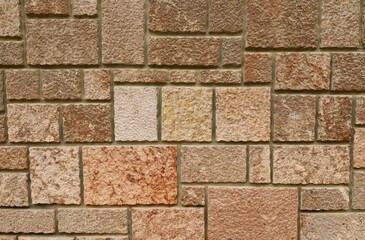Rough stone tiles, granite texture, for exterior. Colors are shades brown, pink, red, yellow and white. Background and texture.