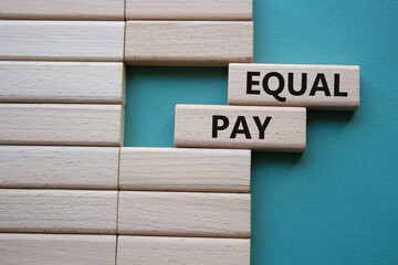 Equal Pay symbol. Wooden blocks with words Equal Pay. Beautiful grey green background.Business and...