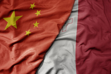 big waving national colorful flag of china and national flag of malta .