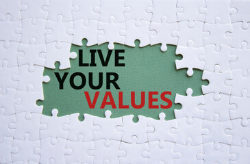 Live your values symbol. Concept words Live your values on white puzzle. Beautiful grey green background. Business and Live your values concept. Copy space.