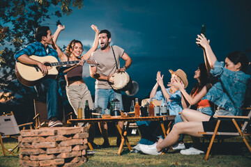 summer party camping of friends group with guitar music, happy young woman and smiling man having...