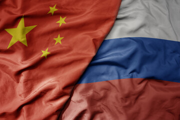 big waving national colorful flag of china and national flag of russia .