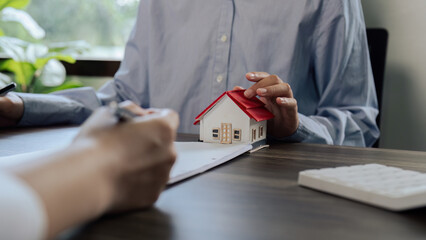 Real Estate Agent explain Property insurance and security concept about house to client before sign...