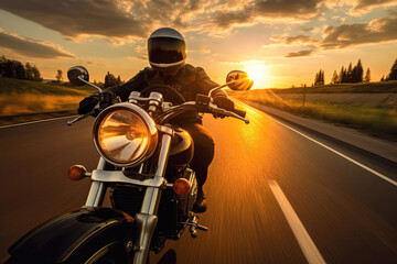 Motorcycle With Motorcyclist Wearing Closed Helmet Riding On An Empty Road At Sunset Wide Angle - obrazy, fototapety, plakaty