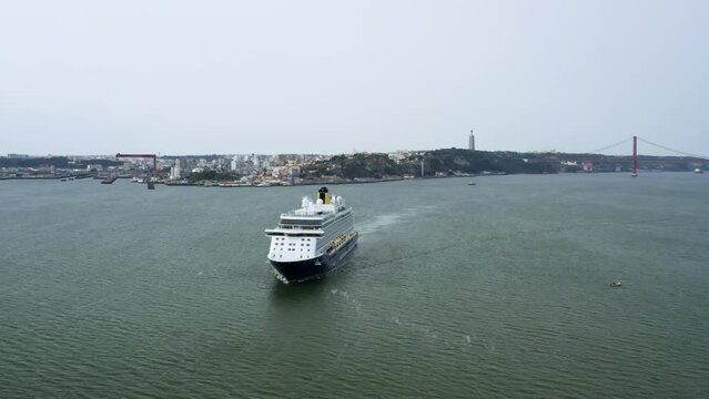 Lisbon, Portugal - February 2, 2023: An aerial view of cruise ship crossing the Tagus river 