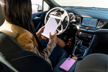 On-the-Road Productivity: Businesswoman Using Tablet and Phone in Car