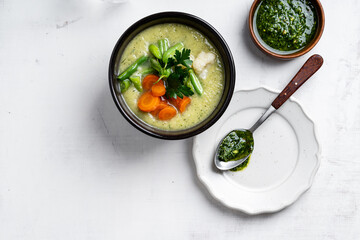 Minestrone soup with parsley pesto sauce, vegetable cream soup