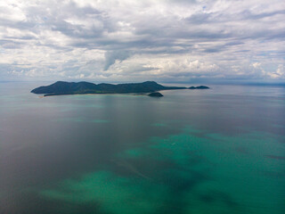 aerial drone panorama of family islands as seen from south mission beach, north queensland, australia; paradise little island surrounded by coral reefs on the shore of pacific