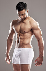 Man, underwear model and muscle care with strong chest, abs and body with wellness in studio....