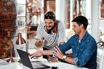 Thats what weve been considering all along. Cropped shot of two young businessmen working together...