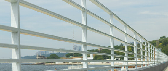 Sea embankment, white handrails on the seashore