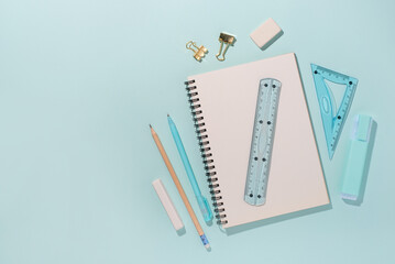 School supplies on blue background. Back to school concept. Top view. Copy space.