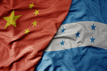 big waving national colorful flag of china and national flag of honduras .