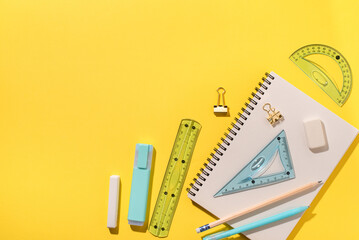 School supplies on yellow background. Back to school concept. Top view. Copy space.
