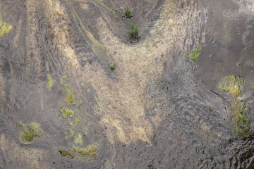 Texture: water slowly flowing out of a concrete dam.