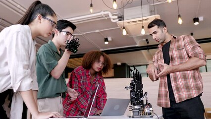 Multiethnic young students listen to teacher about technology robotics mechanisms, high school students in science class demonstrate robots working to replace human hands, science healthcare concept